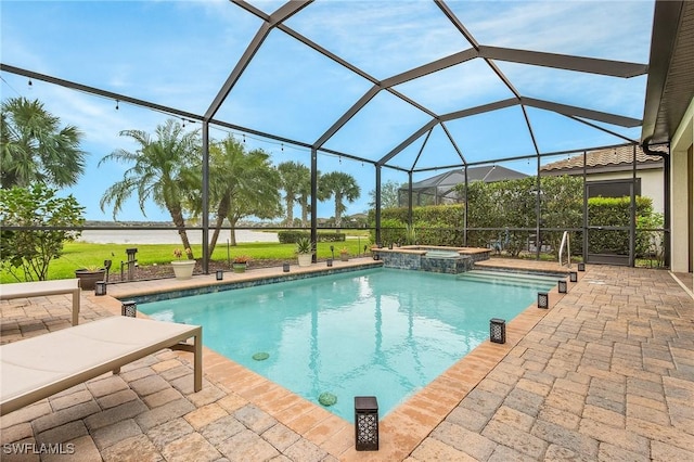 view of pool featuring a pool with connected hot tub, a lanai, and a patio area