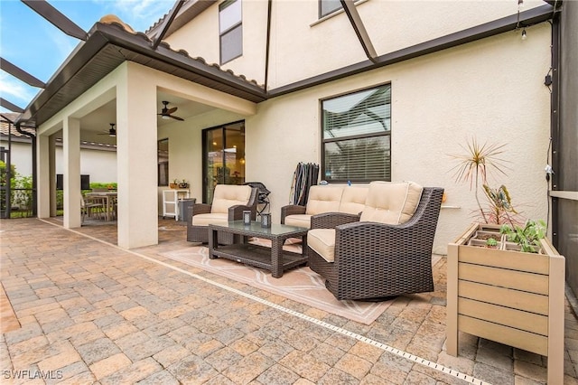 view of patio with a lanai, an outdoor hangout area, and ceiling fan