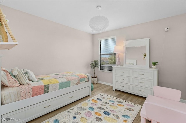 bedroom featuring baseboards and light wood-type flooring