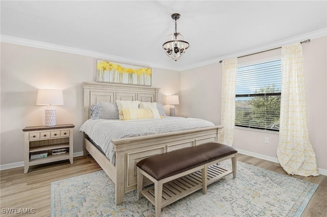 bedroom with light wood-style flooring, baseboards, crown molding, and an inviting chandelier