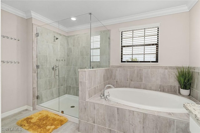 full bathroom with a bath, a stall shower, crown molding, and baseboards