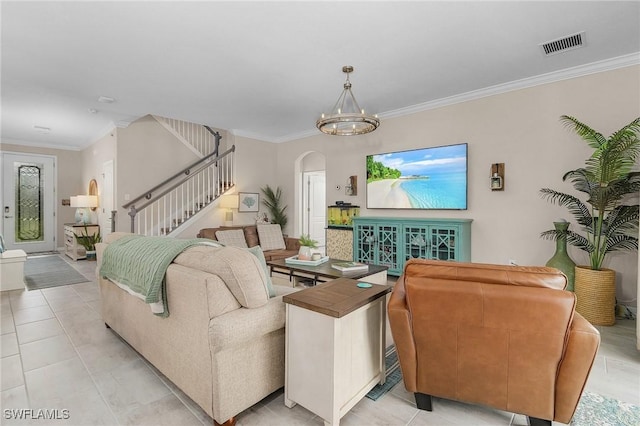 living area featuring crown molding, stairway, arched walkways, and visible vents