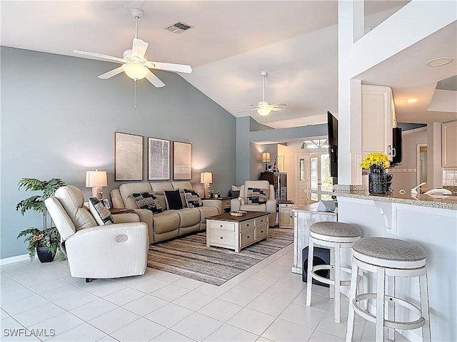 living room with high vaulted ceiling, light tile patterned floors, visible vents, and ceiling fan