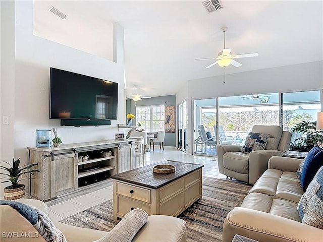 tiled living area with visible vents and a ceiling fan