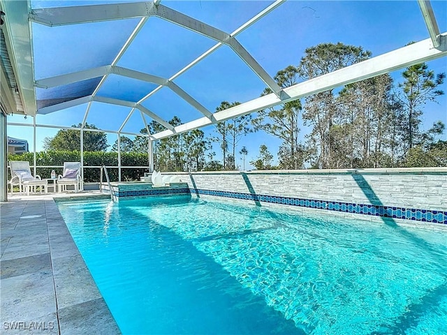 outdoor pool with a lanai and a patio area