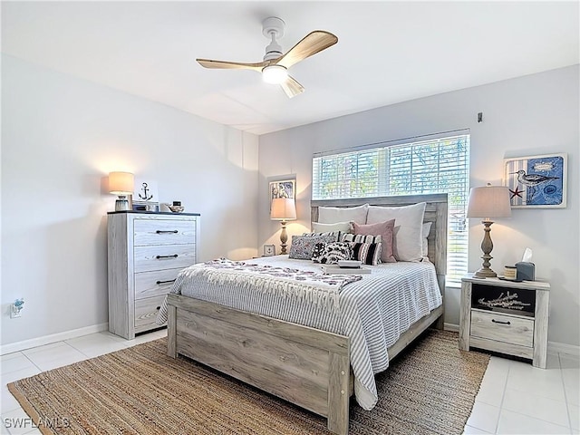 bedroom featuring light tile patterned floors, baseboards, and ceiling fan