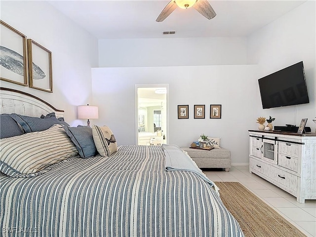 bedroom featuring ceiling fan, light tile patterned floors, visible vents, and connected bathroom