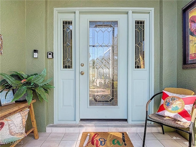 property entrance featuring stucco siding