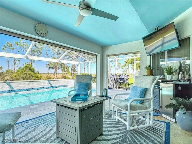 sunroom / solarium featuring a pool and a ceiling fan