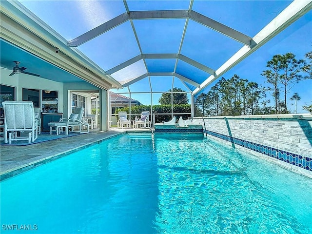 view of pool with a ceiling fan, a patio, glass enclosure, and a fenced in pool