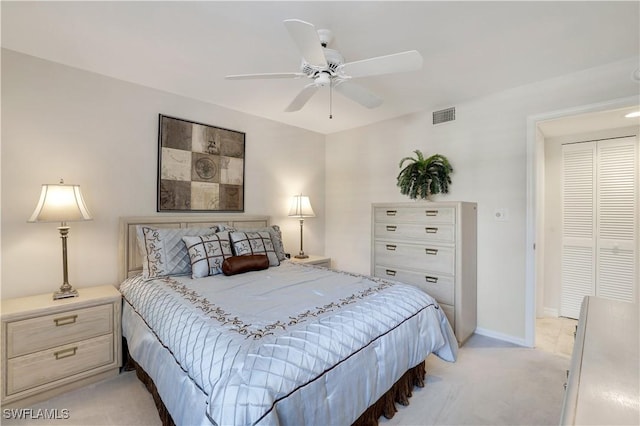 bedroom with baseboards, a ceiling fan, visible vents, and light carpet