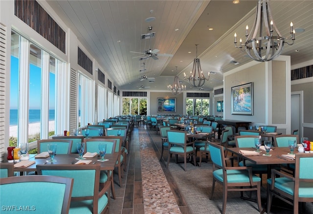 dining area featuring ceiling fan with notable chandelier, visible vents, wood ceiling, and a water view