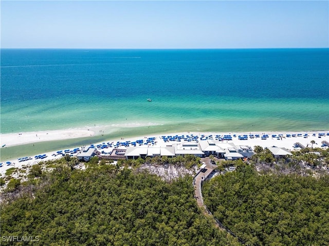 drone / aerial view with a beach view and a water view