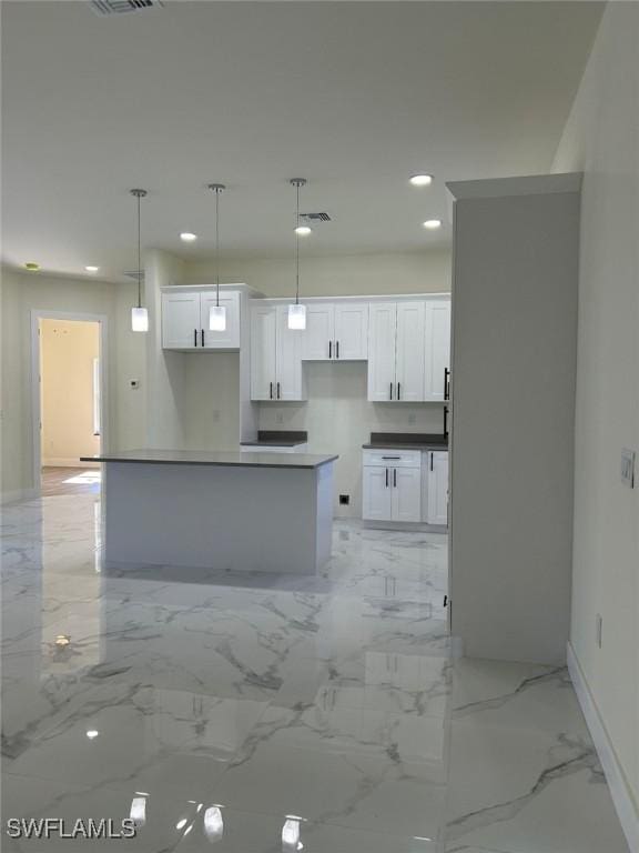 kitchen with visible vents, recessed lighting, pendant lighting, white cabinetry, and marble finish floor