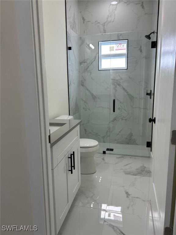 bathroom featuring a marble finish shower, toilet, marble finish floor, and vanity