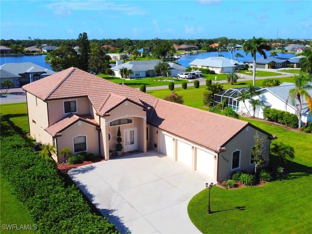 view of front of home with a front yard, driveway, stucco siding, a garage, and a tile roof