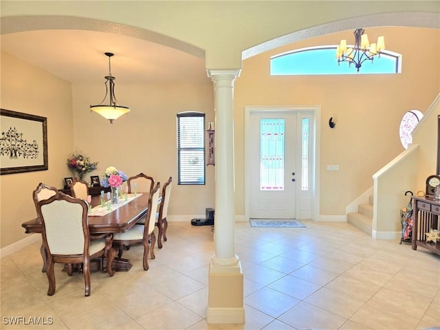11573 SW Dallas Dr N, Lake Suzy, FL 34269 - dining room with ornate columns, a healthy amount of sunlight, light tile patterned floors, and a notable chandelier