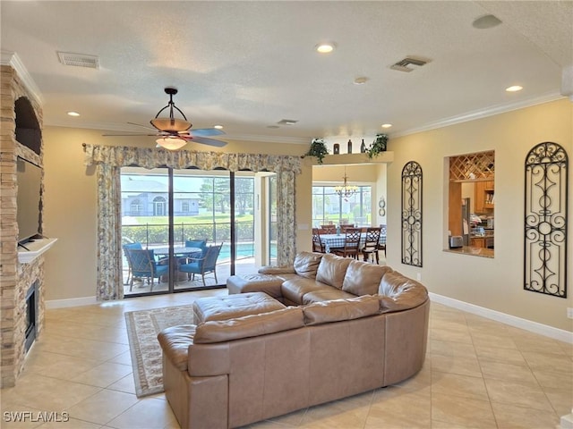 11573 SW Dallas Dr N, Lake Suzy, FL 34269 - living room with light tile patterned floors, ceiling fan with notable chandelier, a stone fireplace, and visible vents