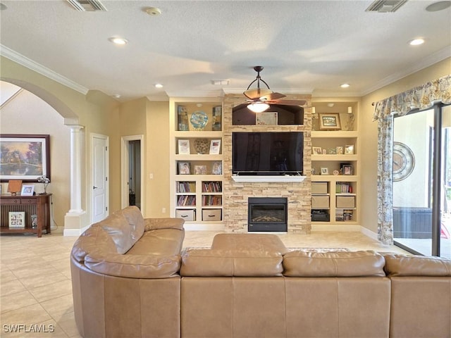 11573 SW Dallas Dr N, Lake Suzy, FL 34269 - living area with ornamental molding, a ceiling fan, built in features, and arched walkways