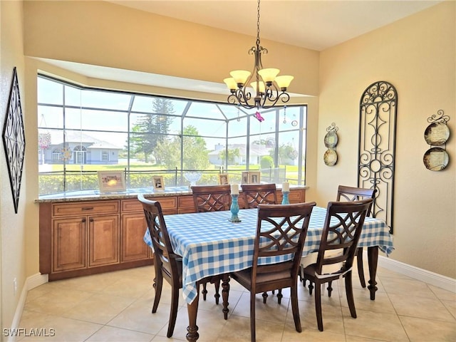 11573 SW Dallas Dr N, Lake Suzy, FL 34269 - dining area with baseboards, a notable chandelier, light tile patterned flooring, and plenty of natural light