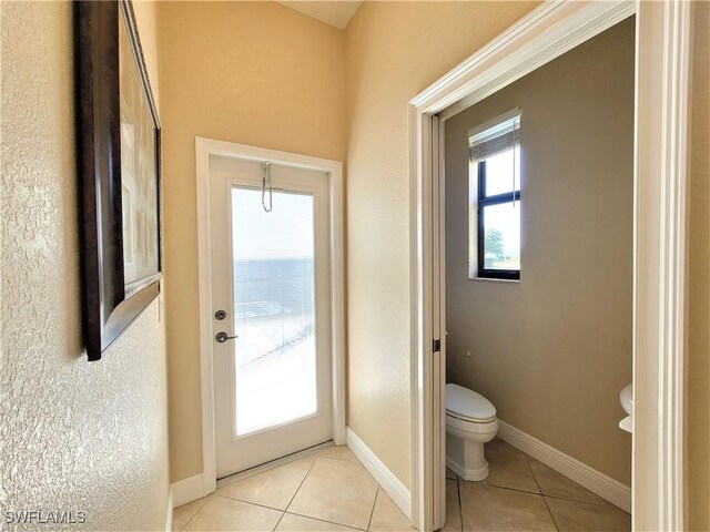 11573 SW Dallas Dr N, Lake Suzy, FL 34269 - entryway with light tile patterned floors and baseboards