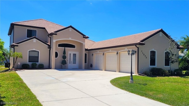 11573 SW Dallas Dr N, Lake Suzy, FL 34269 - mediterranean / spanish-style house with concrete driveway, a garage, a front lawn, and a tiled roof