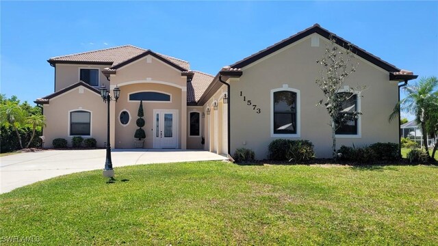 11573 SW Dallas Dr N, Lake Suzy, FL 34269 - mediterranean / spanish-style house featuring a front lawn, stucco siding, and a tiled roof