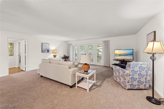 living area featuring carpet flooring and french doors