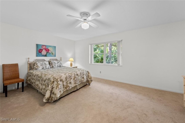 bedroom featuring baseboards, light carpet, and a ceiling fan