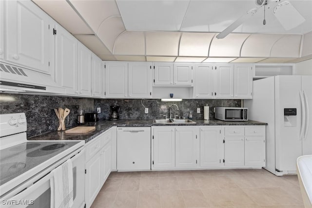 kitchen with white appliances, a sink, decorative backsplash, white cabinets, and under cabinet range hood