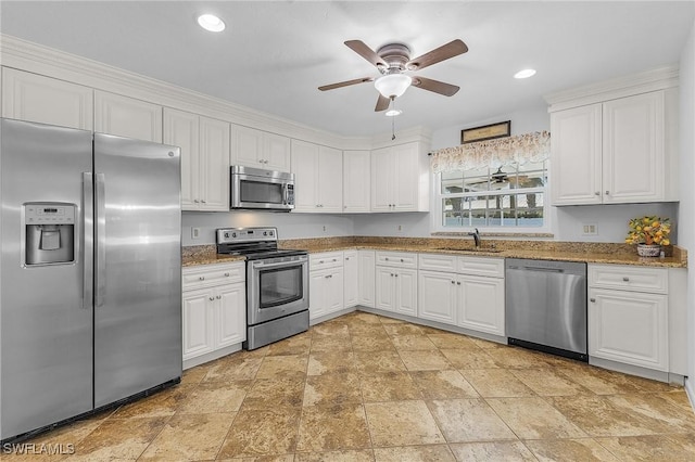 kitchen featuring white cabinetry, ceiling fan, appliances with stainless steel finishes, and a sink