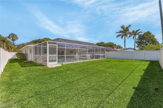 view of yard with a lanai, a fenced backyard, and a fenced in pool