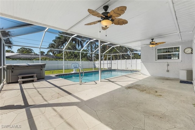 view of pool with glass enclosure, a patio area, a fenced backyard, and ceiling fan