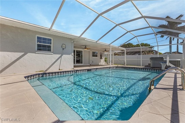 view of pool featuring a fenced in pool, fence, a lanai, a patio, and a ceiling fan