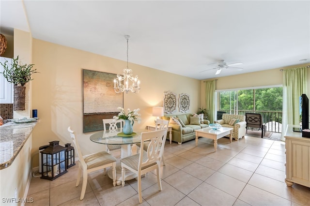 dining room featuring light tile patterned floors and ceiling fan with notable chandelier