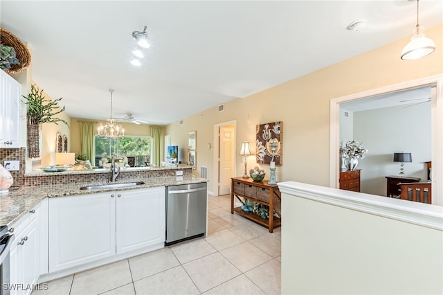 kitchen featuring a sink, decorative light fixtures, appliances with stainless steel finishes, and white cabinetry