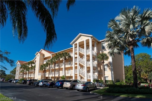 view of building exterior with uncovered parking