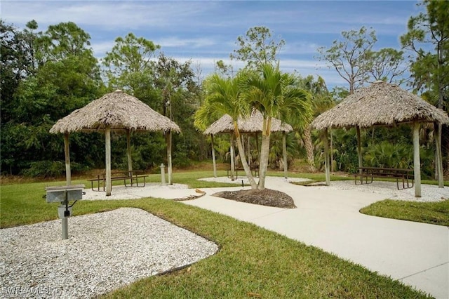 surrounding community featuring a gazebo and a lawn