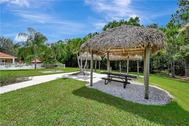 view of property's community with a gazebo, a yard, and fence