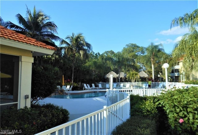 pool featuring a patio area and fence