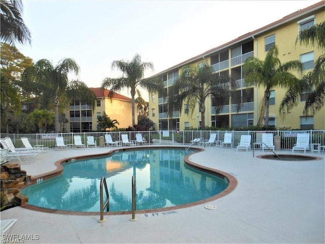 pool featuring a patio area and fence