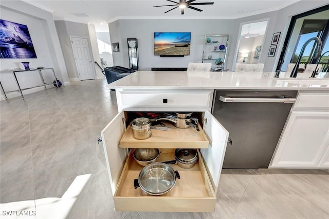 kitchen with crown molding, light countertops, stainless steel dishwasher, white cabinetry, and a sink