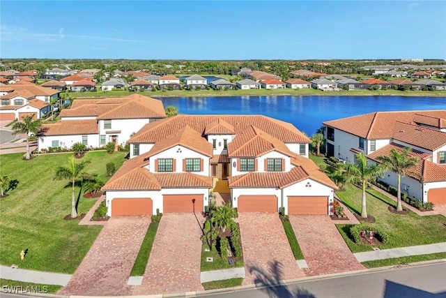 drone / aerial view with a residential view and a water view