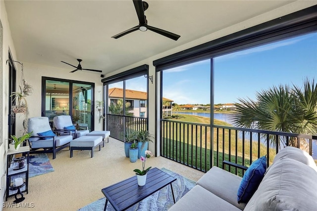 sunroom / solarium with a water view and ceiling fan