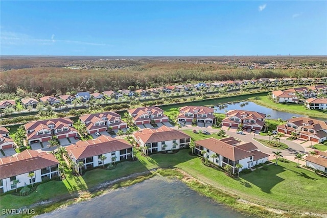 drone / aerial view with a residential view and a water view