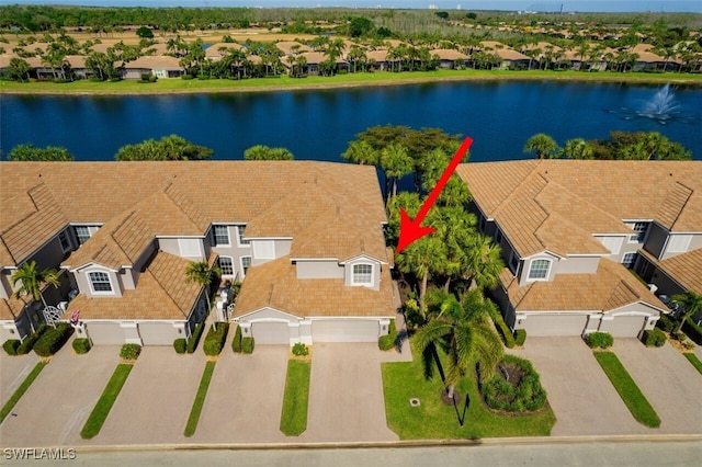 bird's eye view featuring a residential view and a water view