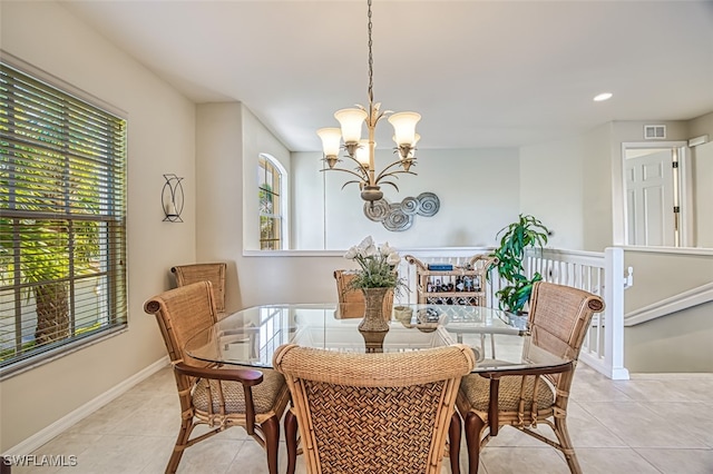 dining area with light tile patterned floors, visible vents, a wealth of natural light, and a chandelier