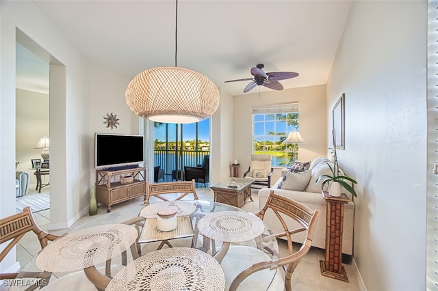 living room featuring baseboards and a ceiling fan