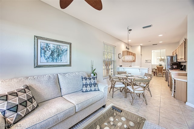 living area with recessed lighting, light tile patterned floors, a ceiling fan, and visible vents