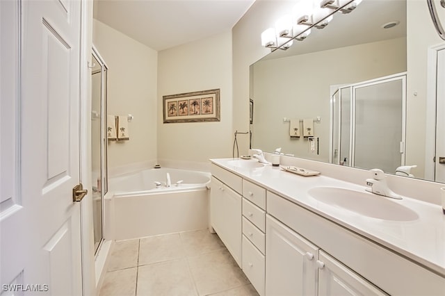 full bath with tile patterned flooring, a stall shower, a garden tub, and a sink